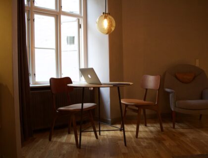 MacBook on table near window