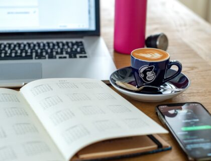 a coffee cup and a pen on a desk